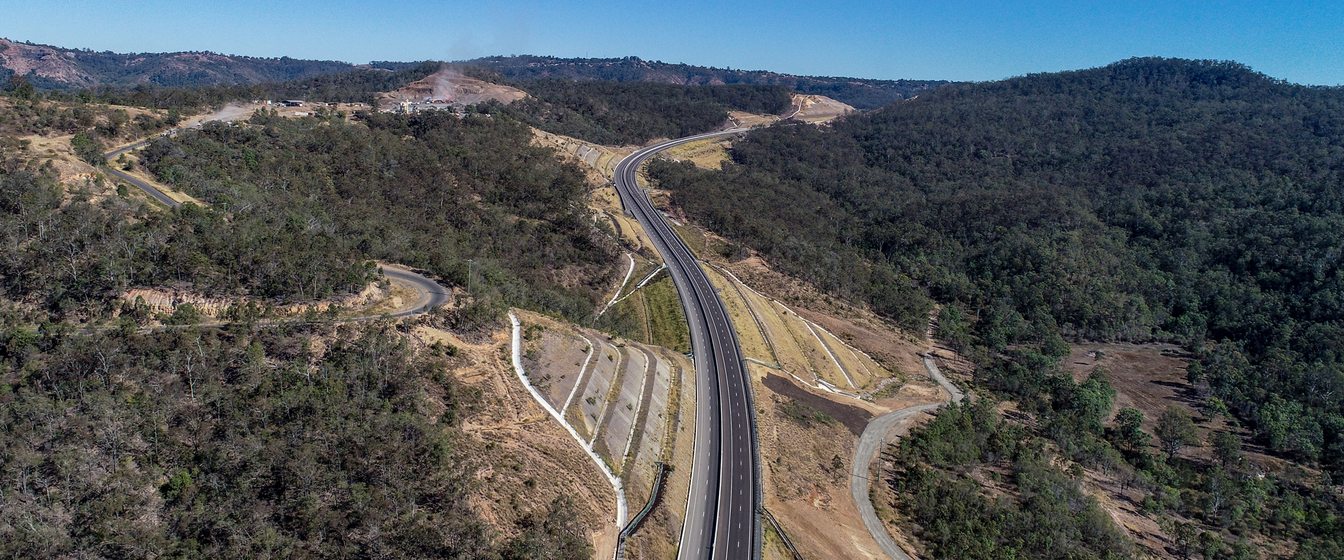 aerial photo of road through mountains